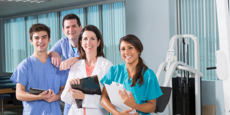 A group of doctors and nurses standing together in a hospital room, collaborating on patient care and treatment plans.